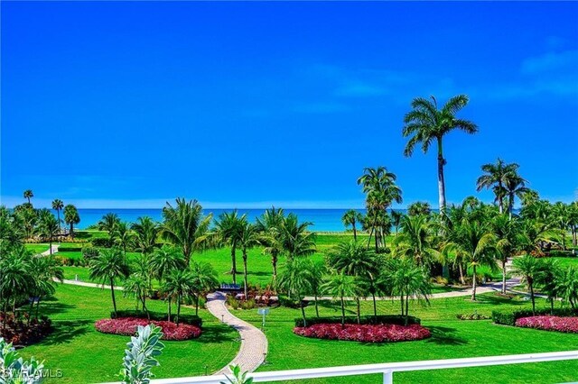 view of community with a lawn and a water view