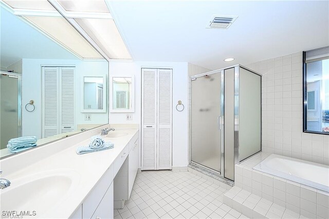 bathroom featuring tile walls, tile patterned flooring, separate shower and tub, and vanity