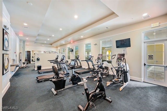 exercise room with a raised ceiling