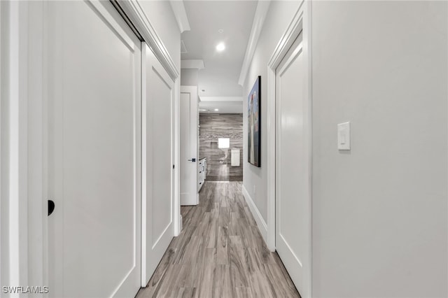 hallway with light hardwood / wood-style floors