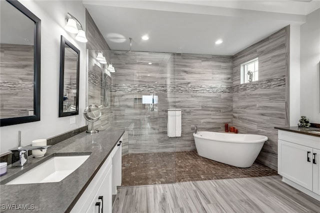 bathroom featuring vanity, separate shower and tub, and hardwood / wood-style flooring