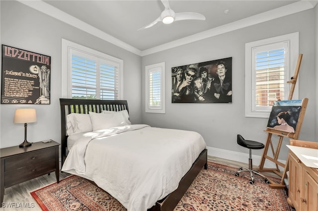 bedroom with crown molding, ceiling fan, and hardwood / wood-style flooring