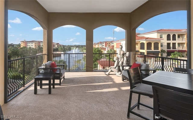 balcony featuring a water view