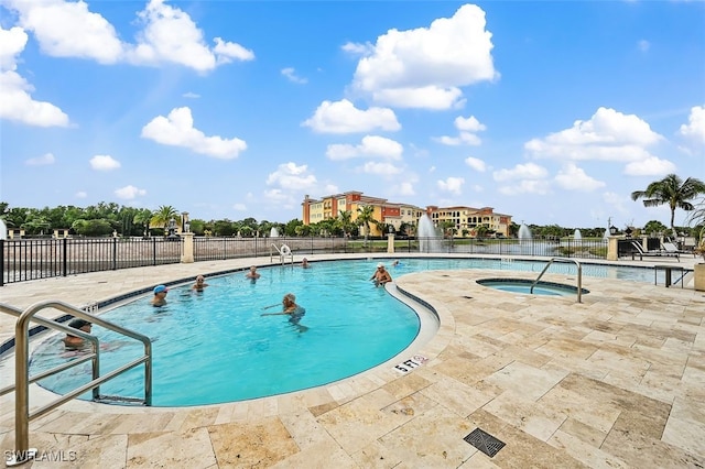 view of swimming pool with a patio and a hot tub