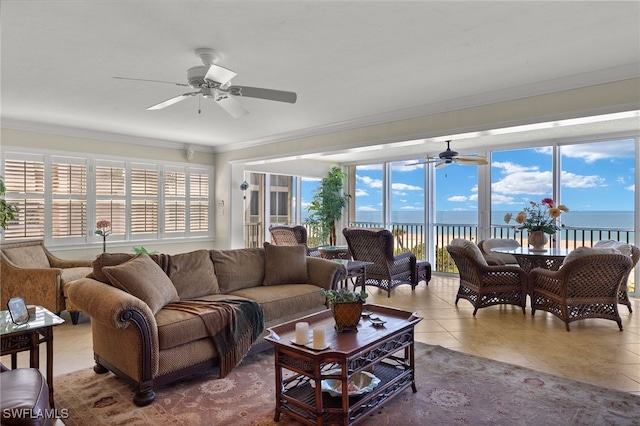 living room featuring a water view, ceiling fan, and tile patterned floors