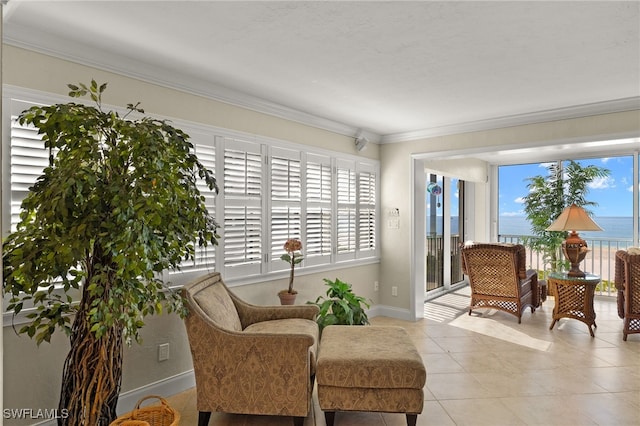 sitting room with crown molding, a water view, and light tile patterned floors