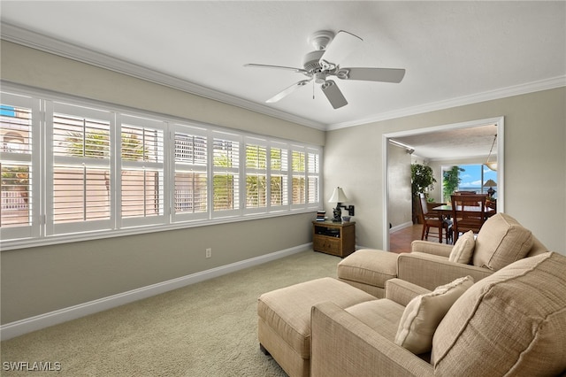 living room featuring crown molding, ceiling fan, and light colored carpet