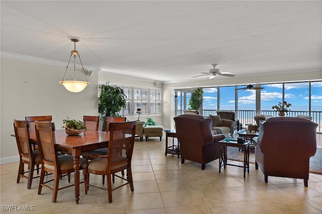 dining area with ceiling fan, light tile patterned flooring, a healthy amount of sunlight, and crown molding