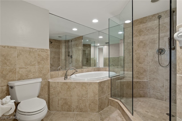 bathroom featuring tile walls, shower with separate bathtub, tile patterned floors, and toilet