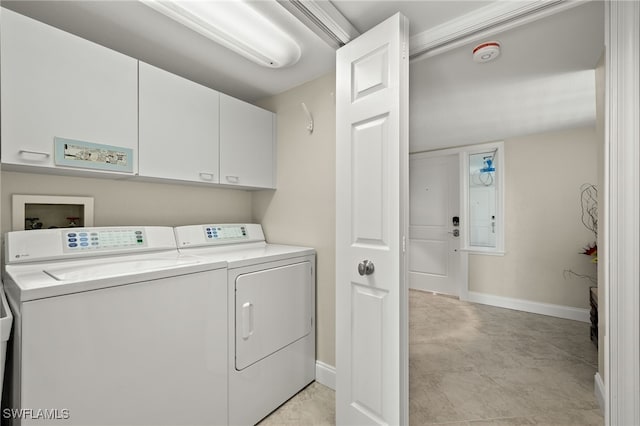 laundry area with washing machine and dryer and cabinets