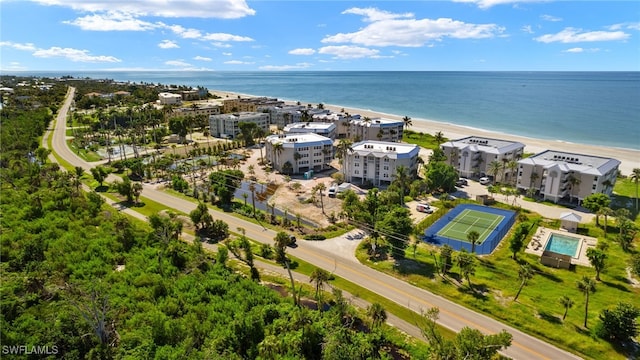 birds eye view of property with a beach view and a water view