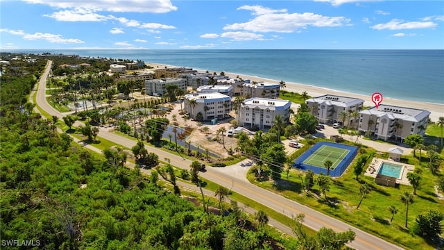 birds eye view of property with a view of the beach and a water view