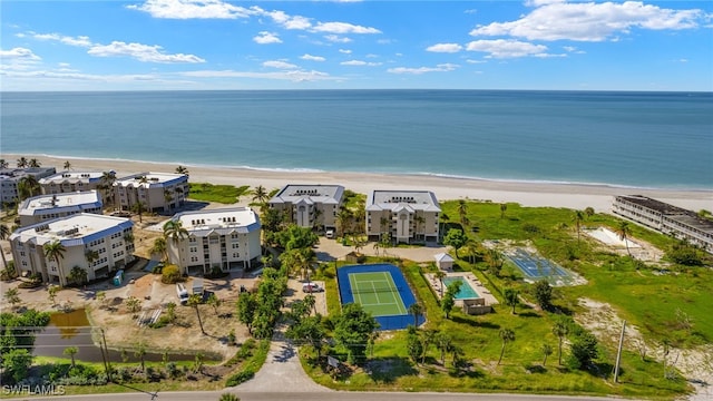 birds eye view of property with a water view and a view of the beach