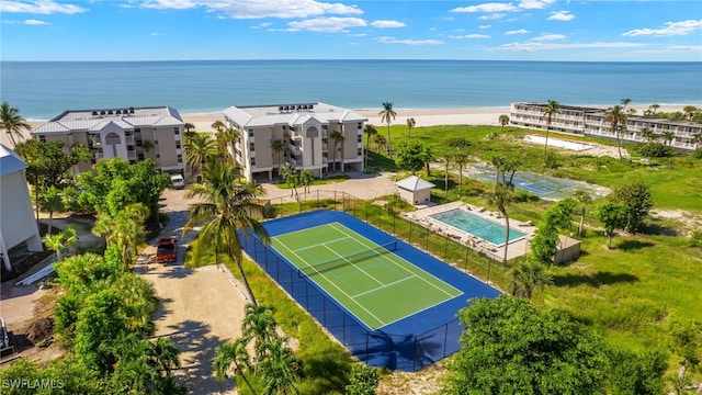 birds eye view of property featuring a water view and a beach view