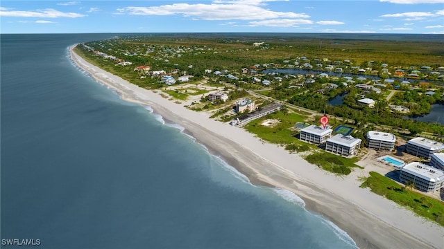 birds eye view of property with a view of the beach and a water view