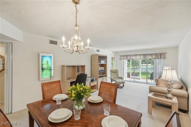 carpeted dining space featuring a chandelier and a textured ceiling