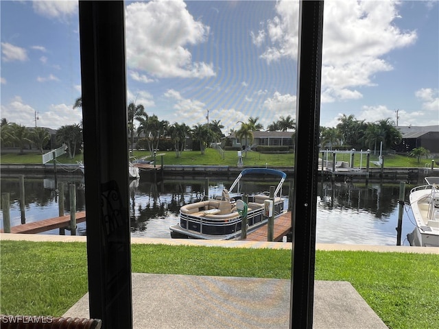 dock area featuring a lawn and a water view