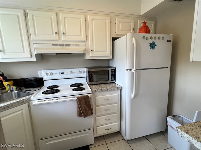 kitchen featuring exhaust hood, light tile patterned flooring, white appliances, and white cabinetry