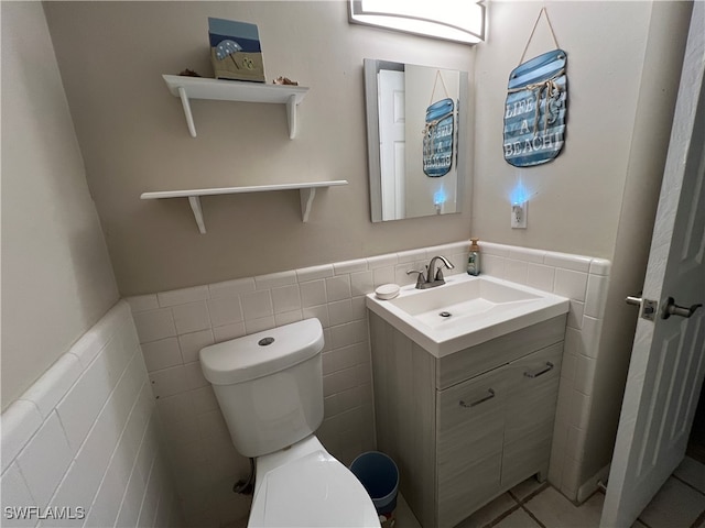 bathroom with tile walls, tile patterned floors, vanity, and toilet