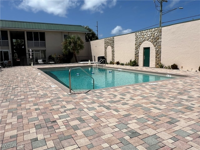 view of swimming pool featuring a patio area