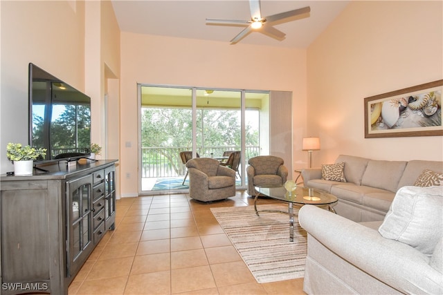 tiled living room with ceiling fan and high vaulted ceiling