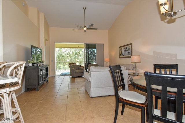 living room featuring ceiling fan, light tile patterned floors, and high vaulted ceiling