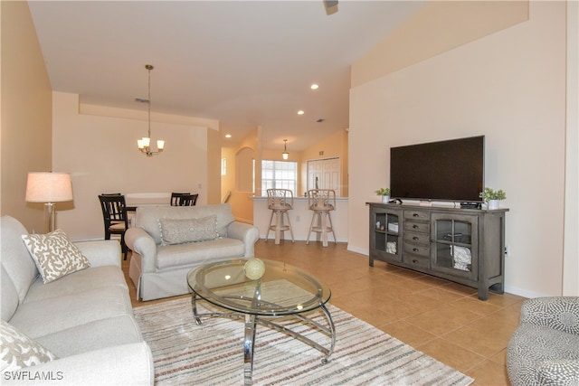 living room with light tile patterned flooring, lofted ceiling, and a notable chandelier