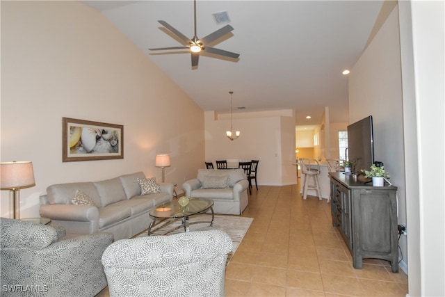 tiled living room featuring ceiling fan with notable chandelier and high vaulted ceiling