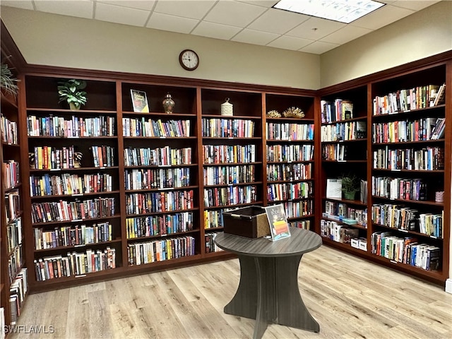 interior space featuring a paneled ceiling and hardwood / wood-style flooring