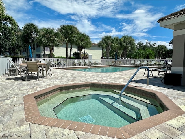 view of pool with a community hot tub and a patio area