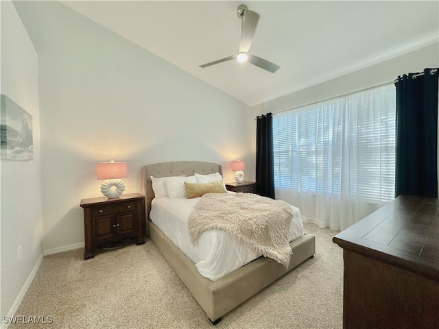 carpeted bedroom with ceiling fan and lofted ceiling