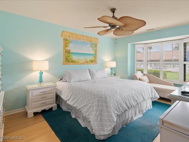 bedroom with light hardwood / wood-style flooring and ceiling fan