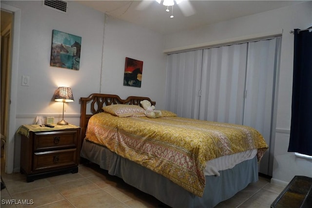 tiled bedroom with ceiling fan