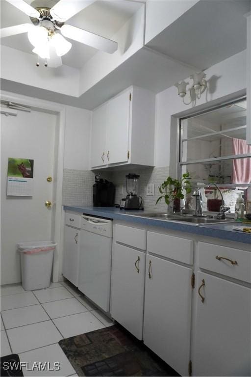 kitchen with backsplash, dishwasher, white cabinets, and sink