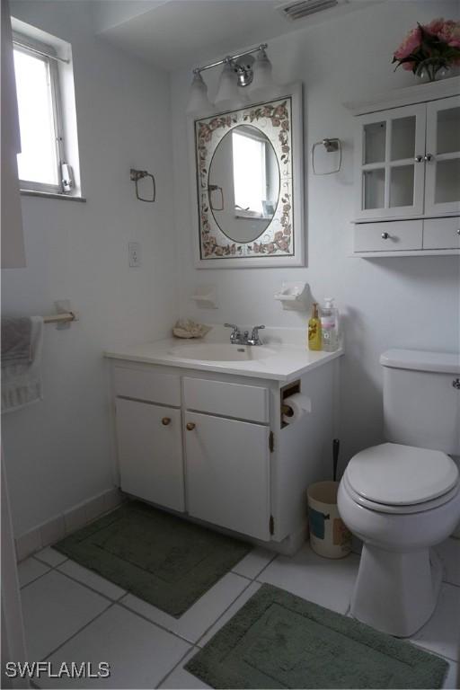 bathroom with tile patterned floors, vanity, and toilet