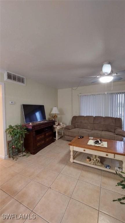 tiled living room featuring ceiling fan