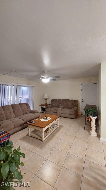 unfurnished living room featuring ceiling fan and light tile patterned flooring