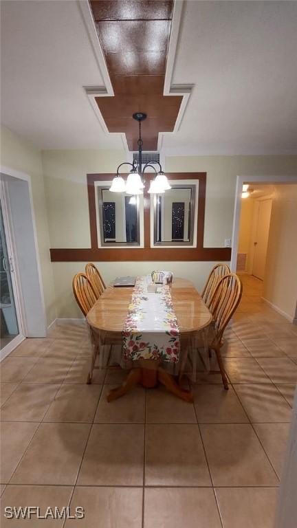 unfurnished dining area with tile patterned flooring and a chandelier