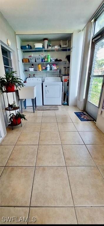 interior space featuring light tile patterned floors and washing machine and clothes dryer