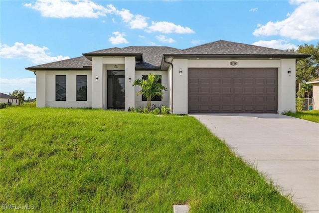 view of front of home with a garage and a front lawn