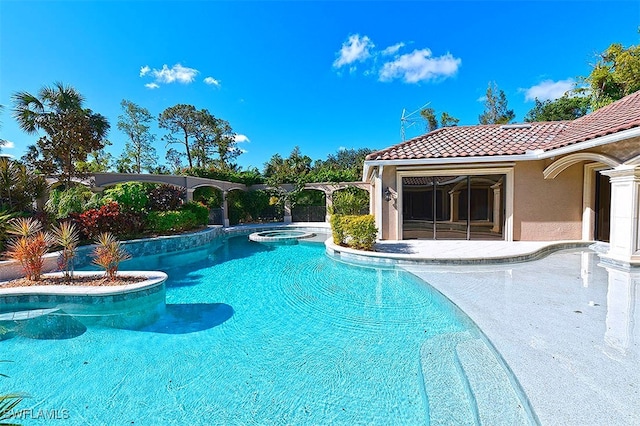 view of swimming pool with an in ground hot tub and a patio area