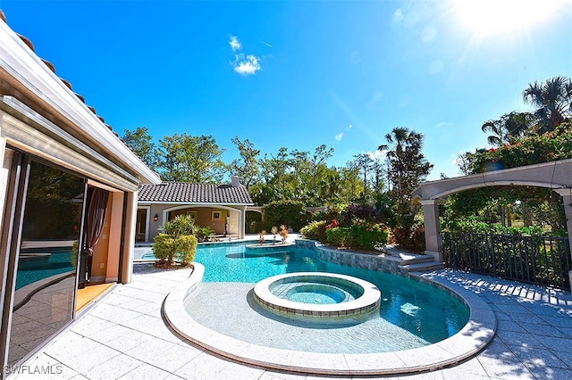 view of pool with a patio and an in ground hot tub