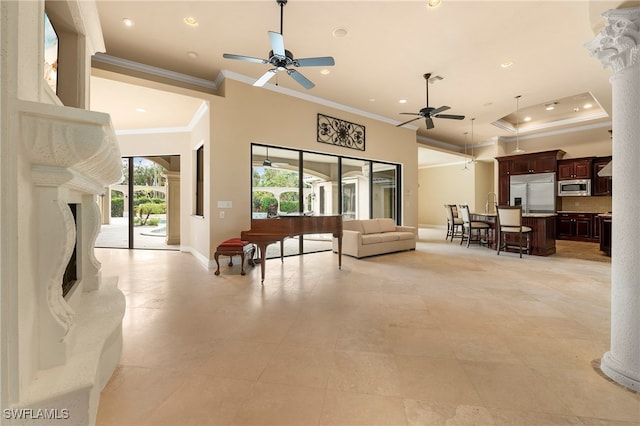 living room with a high end fireplace, crown molding, light tile patterned flooring, and ceiling fan