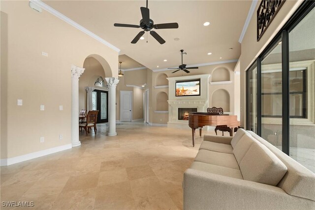 interior space with built in shelves, ornamental molding, decorative columns, and ceiling fan