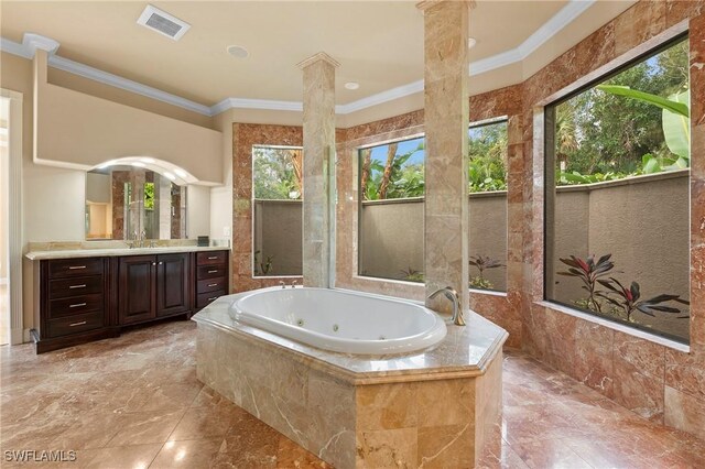 bathroom featuring a relaxing tiled tub, vanity, and crown molding