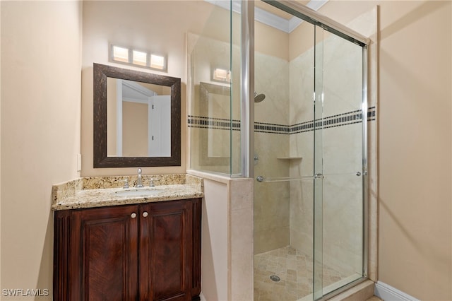 bathroom featuring ornamental molding, walk in shower, and vanity