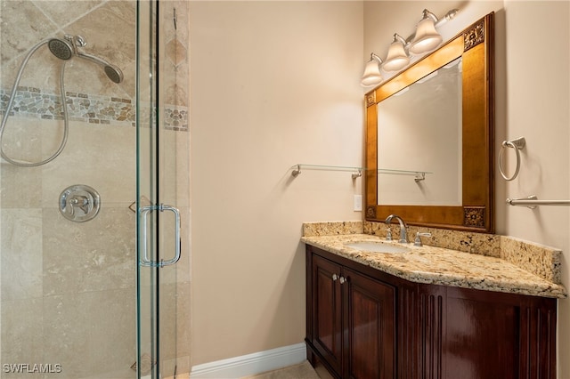 bathroom with vanity and a shower with shower door