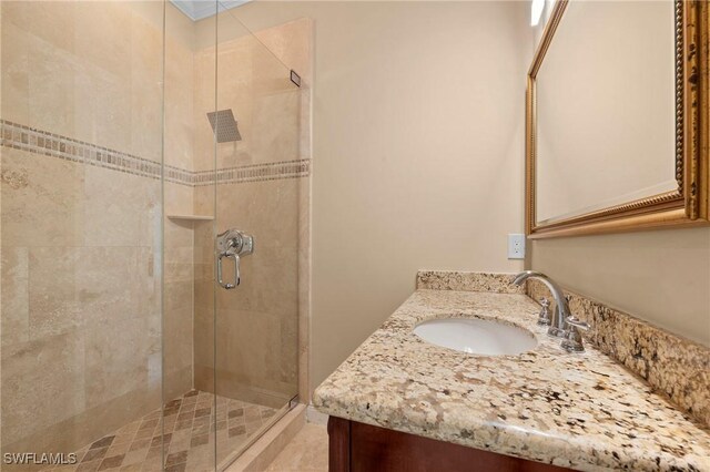 bathroom featuring vanity and a shower with door