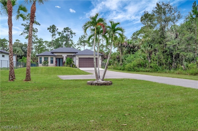 view of front facade with a front lawn and a garage