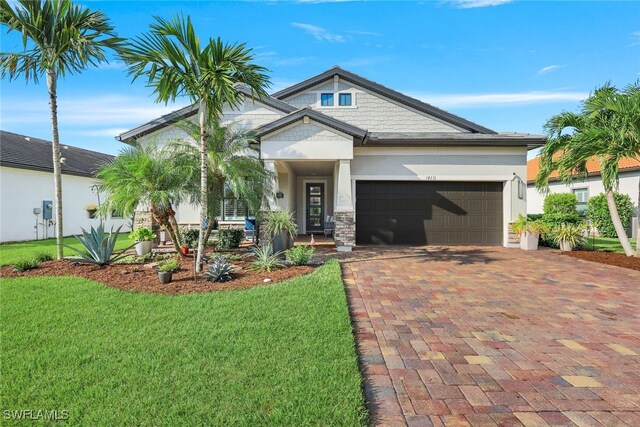 view of front of property with a front yard and a garage